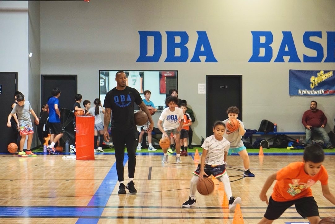 DBA coach leading a youth training session on the court